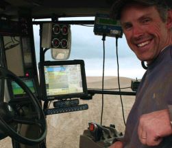 Eric Odberg drives farm machinery equipped with screens for use in precision agriculture.